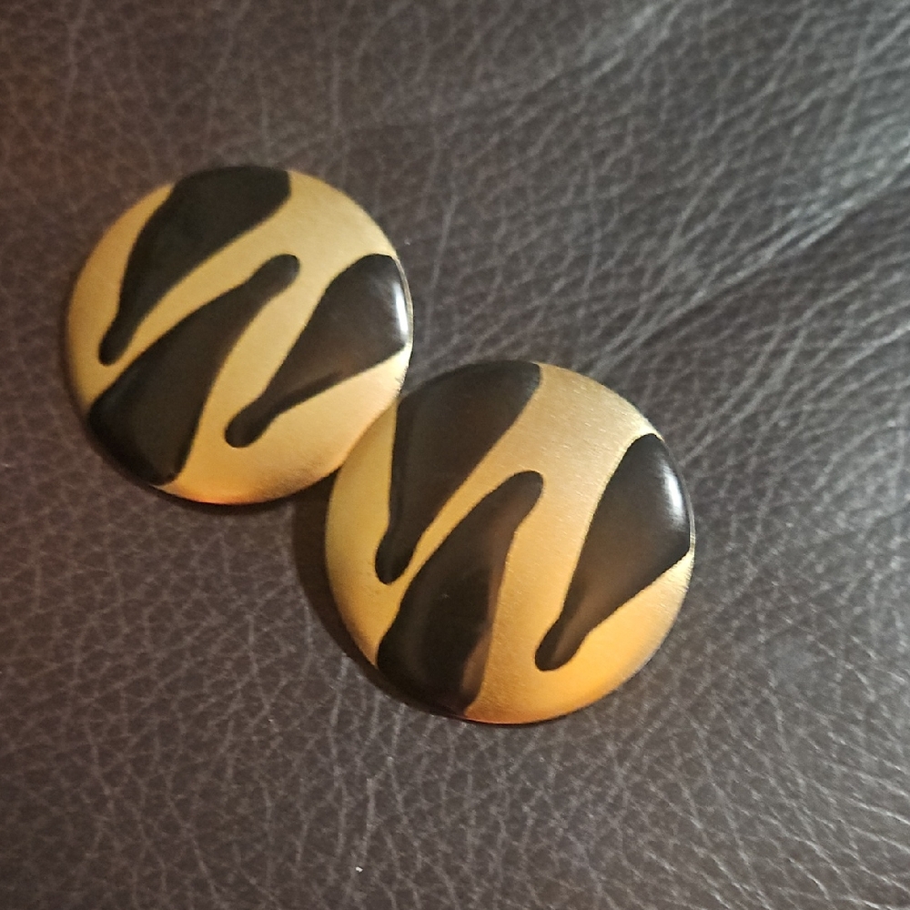 Gold-tone Round Clip Earrings with Black Drip Design